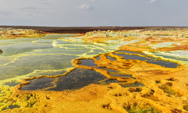Layered mineral terraces and sulfur pools in Dallol geothermal landscape, Ethiopia