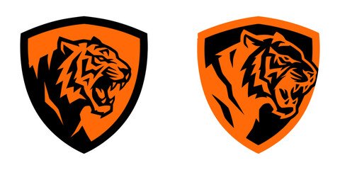 Fototapeta premium Tiger head logo set featuring roaring feline inside shield designs symbolizing strength