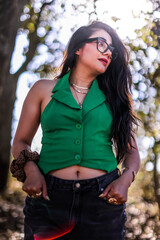 A close up head shot portrait of a preppy, young, beautiful, confident and attractive Mexican woman. Enjoying her happy life. Happy young girl