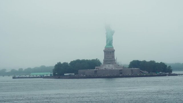 Dramatic fog surrounding Statue of Liberty in New York Harbor