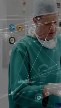 Vertical video: Camera pulling back surgeon checking blue tool for prep while HUD marking ports