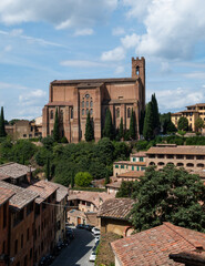 Obraz premium Hilltop Gothic church overlooking historic Italian town