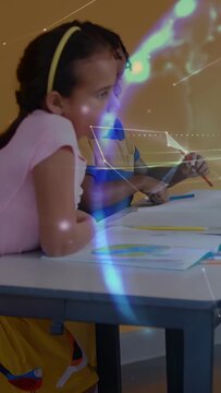 Vertical video: Boy marking sheet with blue pencil sparking holo in class, girl coloring to finish