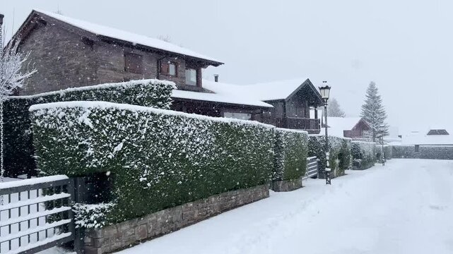 Snow falling in a mountain village street in Puigcerda