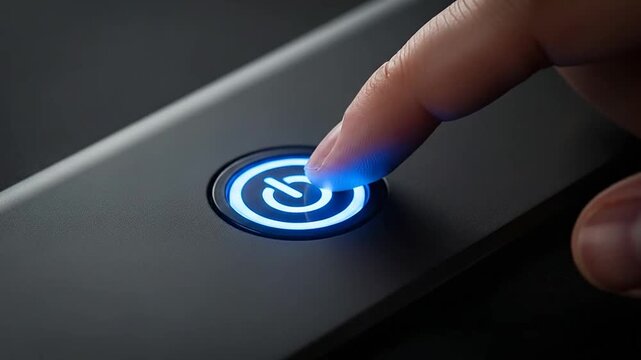Finger pressing a glowing power button.