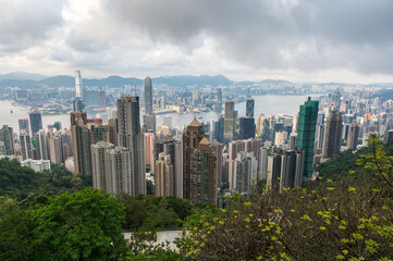 Fototapeta premium View of Hong Kong and Kowloon from Victoria peak. Panorama of Hong Kong, skyscrapers and nature. 21 May 2025, Hong Kong, China