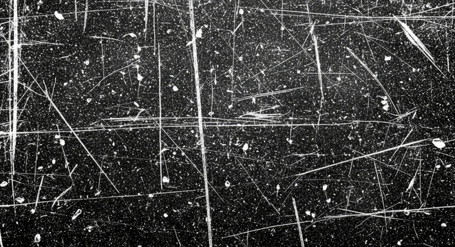 Black scratched surface with white marks.