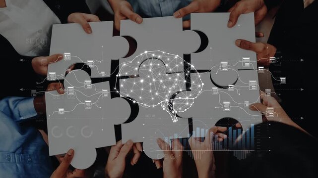 A diverse group of individuals collaborates to piece together puzzle parts, symbolizing teamwork with a brain graphic and data visuals, emphasizing innovation in a modern workspace. Raster