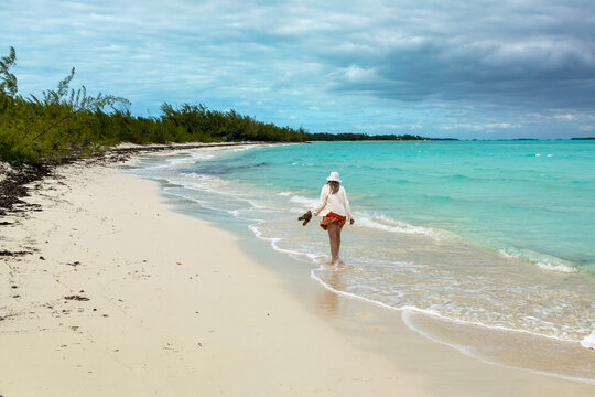 Woman Walking along Coco Plum Beach Exumas