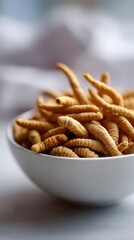 Fototapeta premium Cordyceps sinensis health products displayed in a white bowl, showcasing the unique elongated shape and texture of the fungi against a soft blurred background