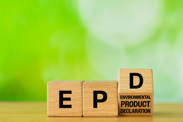 Symbol EPD, Environmental Product Declaration. Data on the products impact on the environment throughout its life cycle. Business concept written on wooden blocks. Green background. Copy space © Rochu_2008