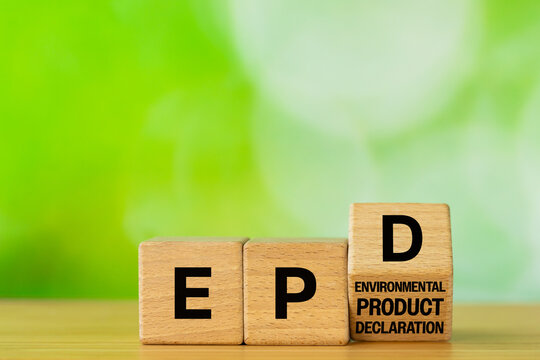 Symbol EPD, Environmental Product Declaration. Data on the products impact on the environment throughout its life cycle. Business concept written on wooden blocks. Green background. Copy space
