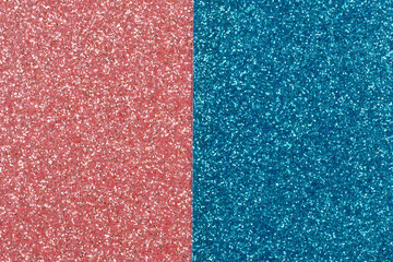 Fototapeta premium A shimmering background featuring a sharp vertical split between sparkling coral pink and deep teal blue glitter textures