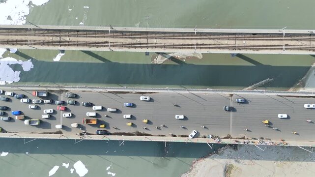 Aerial 4k view of Pollution in Yamuna River, Foam in river water and heavy traffic jam at Kalandi Kunj, Delhi, India