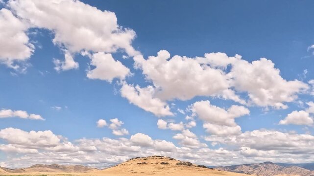 Clouds roll by the Sierra Nevada mountain range and its foothills