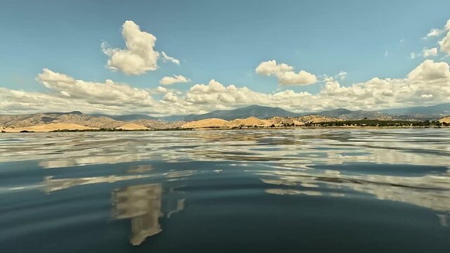 Water lapping at camera with Sierra Nevada mountains in background