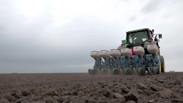 Modern Agriculture &ndash; Tractor Sowing Sugar Beet on Farmland; Tractor with seeder sowing sugar beet on agricultural land