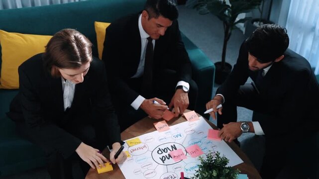 Top view of skilled businessman write marketing idea and drawing mind map while project manager explain financial strategy at meeting room. Professional startup team brainstorm idea. Directorate.