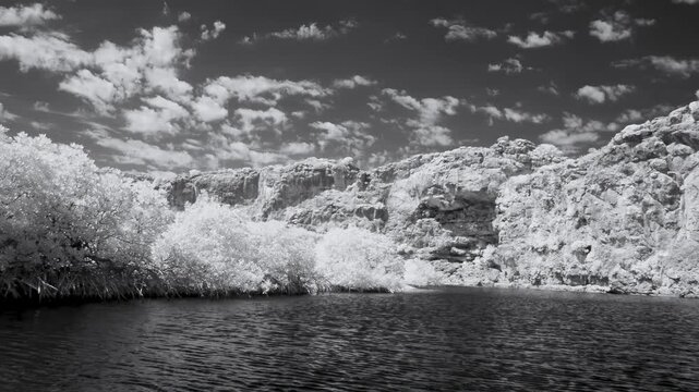Cruise along Yardie Creek with river vegetation and rocks infrared dramatic view