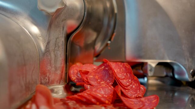 professional slicer cuts pepperoni sausage