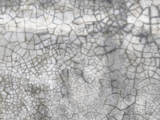Obraz premium Texture of grey cracked concrete wall background with intricate dark fissures. Detailed weathered cement surface featuring distressed pattern and grungy aesthetic for industrial design projects.