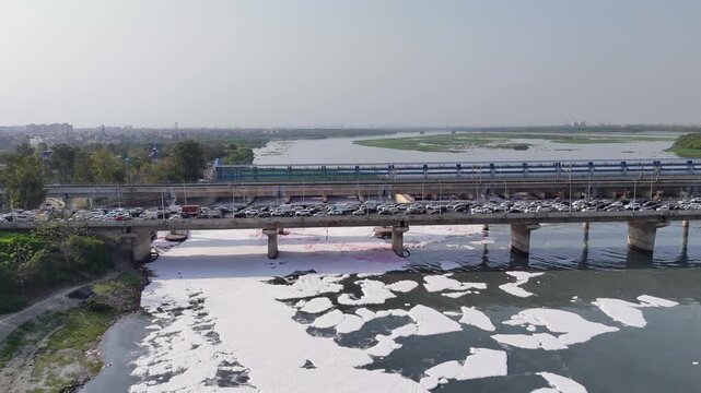 Aerial 4k view of Pollution in Yamuna River, Foam in river water at Kalandi Kunj, Delhi, India