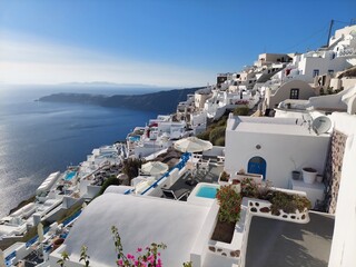 Fototapeta premium Whitewashed houses with terraces and pools and a beautiful view in Imerovigli on Santorini island, Greece
