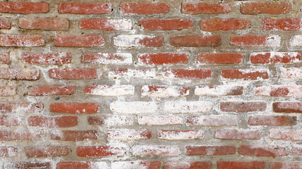 Red brick wall with heavy weathering and white efflorescence, textured, eroded masonry surface showing cracks, decay and vintage industrial character for backgrounds © Newleks