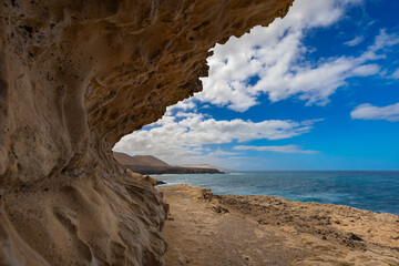 Rock formations and caves on the Atlantic Ocean coast in Ajuy, Fuerteventura, wallpaper or background for your project © anettastar