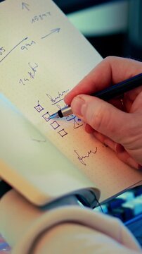 Checklist Notebook Planning Closeup, pen marking task boxes, handwritten notes, business organization, productivity routine, project preparation, strategic workflow