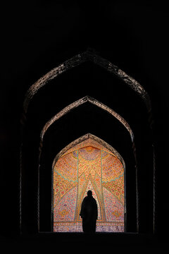 Silhouette of Iranian woman in national dress at background of traditional Persian architecture. Iran. Persia.
