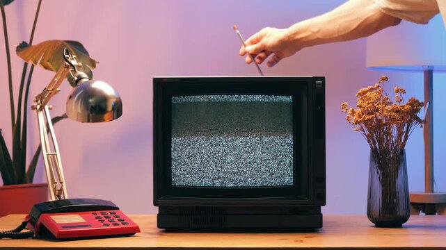 Retro TV, vintage television In a nostalgic setup, a retro TV displays grain on screen, scary halloween night device good for chroma key and green screen.