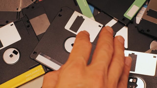 Floppy disc FDD close up, Using diskette for old PC computer macro. Archive programme or Music recorder, playing retro computer games. Vintage device for office, obsolete technology. 