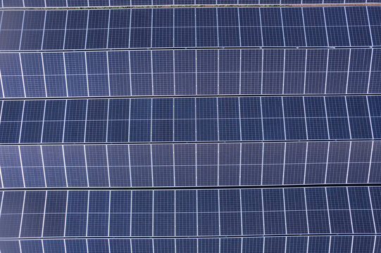 Top down aerial view of photovoltaic solar panels for clean energy.