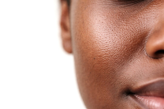 Extreme close up of African American woman skin texture. Microscopic view of pores and face surface. Natural beauty skincare concept for dermatology, cosmetic treatment and health care.