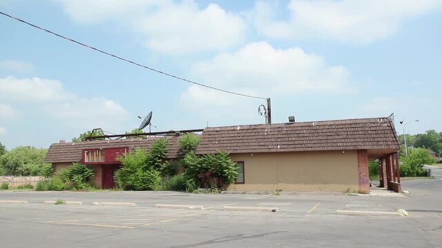 Abandoned restaurant with overgrown parking lot. Welland, Ontario, Canada. HD video.