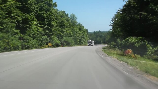 Summer RV. Passing a camper van on the road. Summer in Ontario, Canada. HD video. 