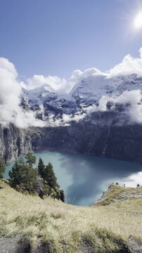 Scenic Lake Oeschinen in Switzerland with turquoise alpine water, dramatic mountain peaks and peaceful natural landscape in the Bernese Oberland, perfect for travel, hiking and tourism concepts