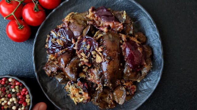 Chicken, duck, or goose liver with plums, onions, and spices. Chicken liver as a food background for your design