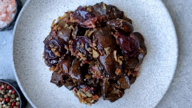 Chicken, duck, or goose liver with plums, onions, and spices. Chicken liver as a food background for your design