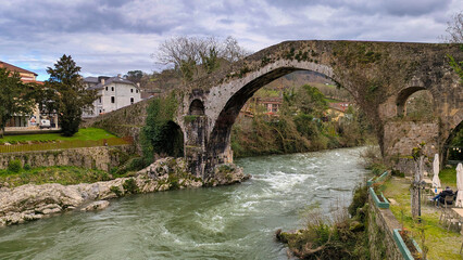 Fototapeta premium Old Roman stone bridge in Cangas de Onis over Sella river, Asturias, Spain