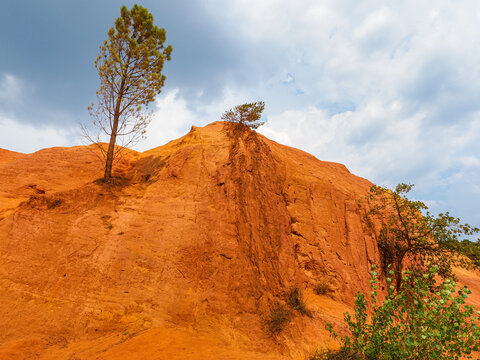 Spectacular colorful valley. Rustrel France. The Provence Colorado. Walks in strange desert scenery with orange red rock formations in former ocher-mining quarries. Beautiful landscape.