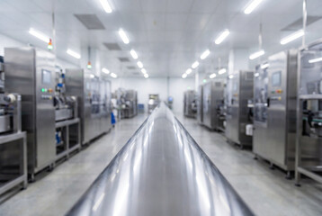 Fototapeta premium A long gleaming stainless steel pipeline on a modern industrial factory floor