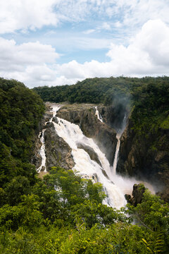 Barron Falls in full flow, a majestic tiered cascade plunging through the lush green rainforest of Barron Gorge National Park near Kuranda and Cairns, Queensland, Australia