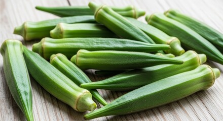 Fototapeta premium Fresh Okra Pods Arranged on a Wooden Surface