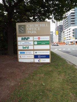Ottawa, Ontario, Canada-July 22, 2025: A pylon directory for "Churchill Office Park" lists various professional tenants on Carling Ave.
