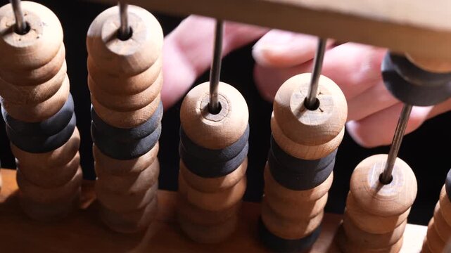 Macro view of vintage wooden abacus beads on rods representing counting calculation education finance and business accounting concept