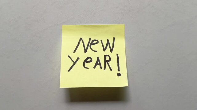 New Year message on sticky note isolated on white background