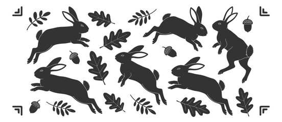 Fototapeta premium Black rabbits and oak leaves scattered on white background