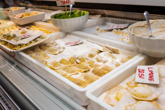 Genoa, liguria, italy. May 18, 2024. Fresh ravioli, pansoti and assorted handmade pastas displayed at a genoa market stall, ready for purchase and cooking